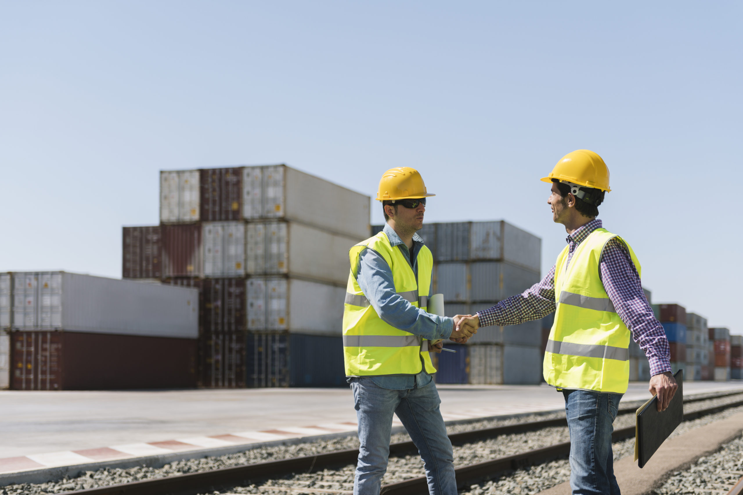 workers shaking hands on railway tracks near cargo 2022 03 08 01 02 33 utc