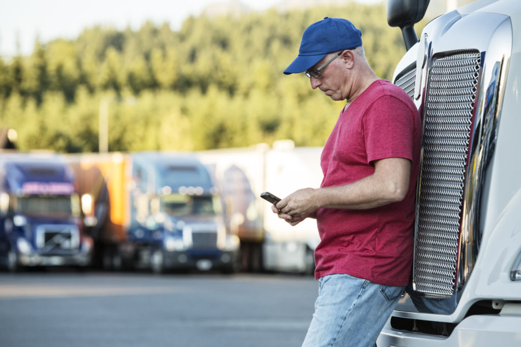 Truck driver passing time on his phone