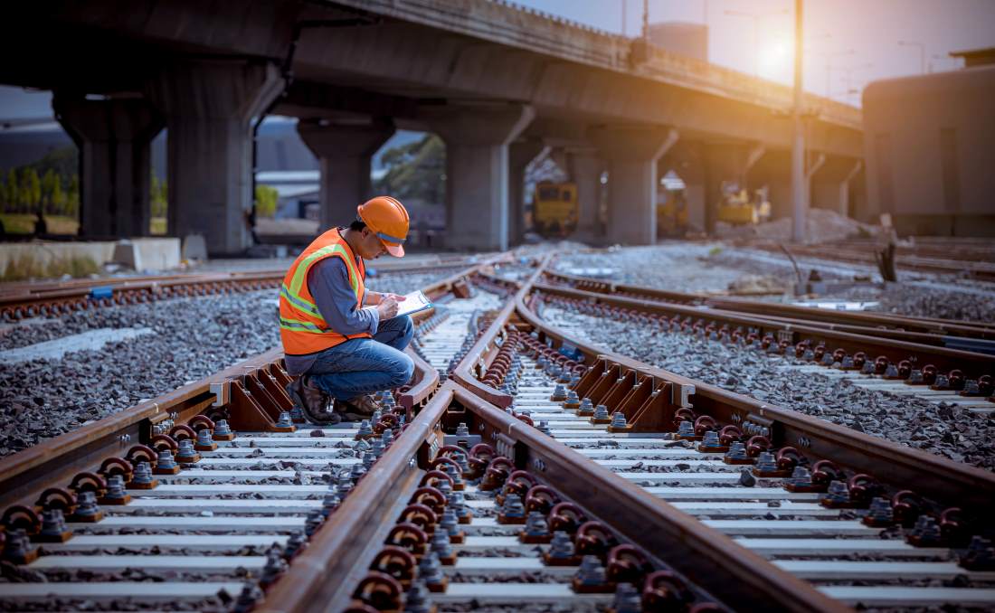 A man working on railroad tracks in PPE