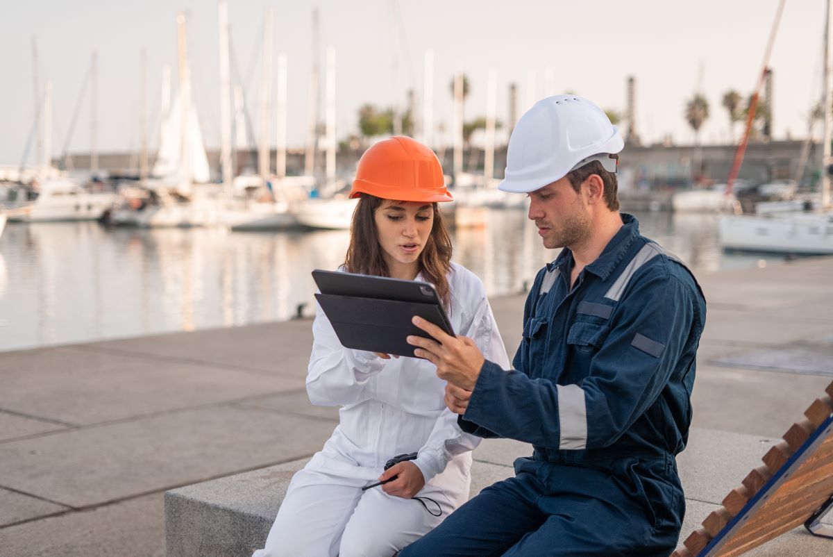 marine terminal port employees analyzing data on a tablet