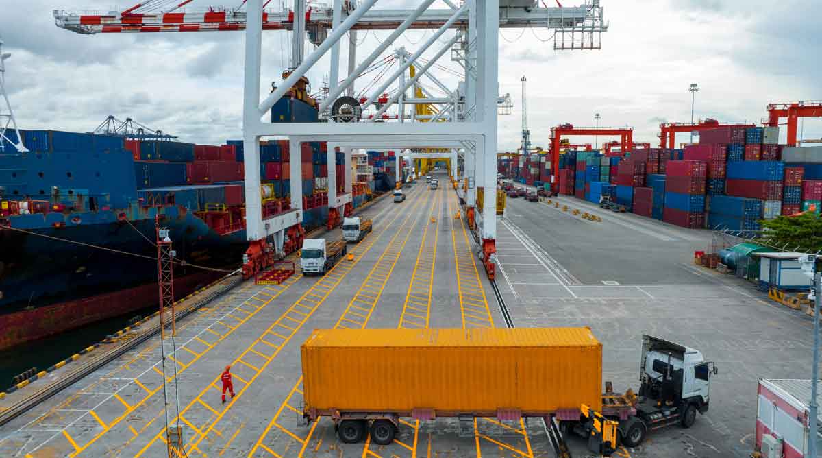 cargo container truck under big loader crane